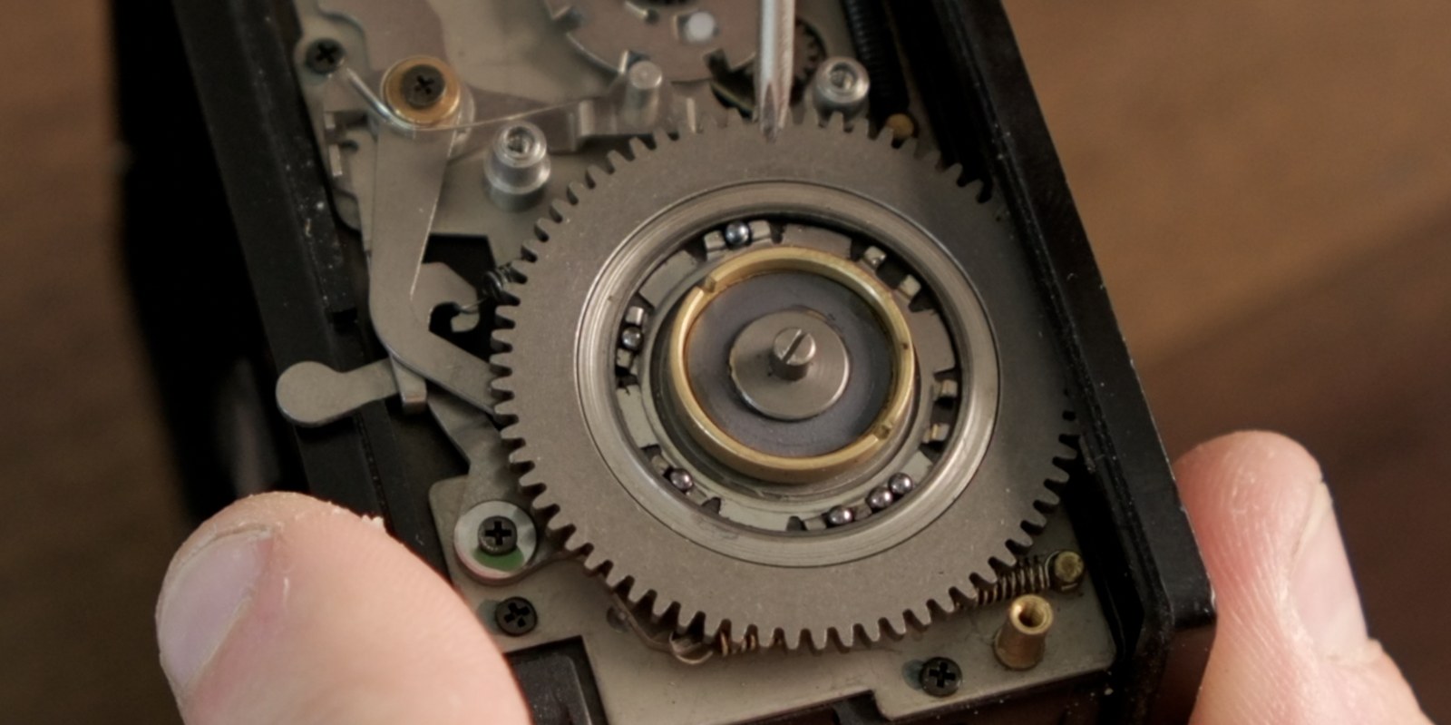 Open film back showing the ball bearings under the lifted lever plate.