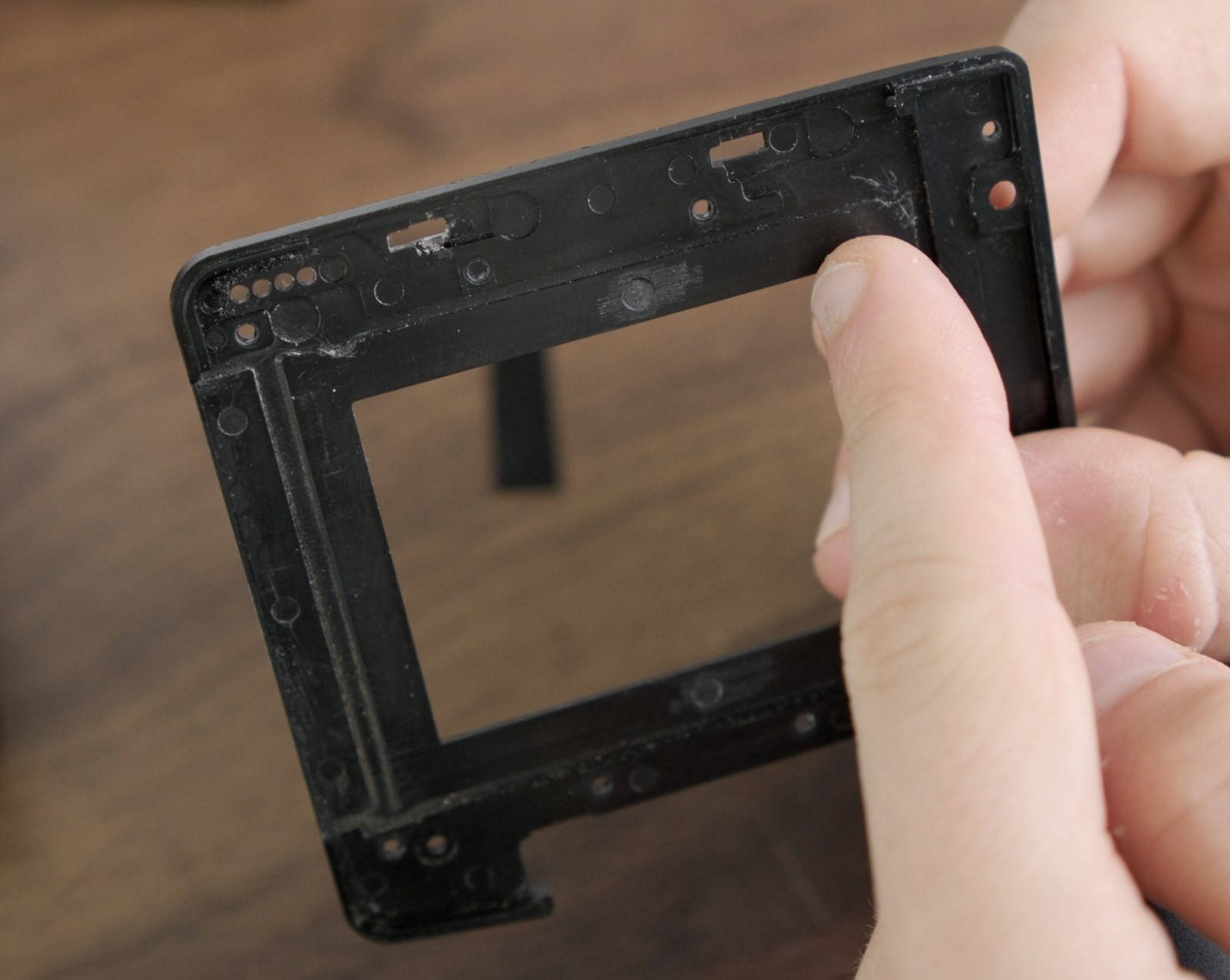 Reverse side of the front panel showing molded cutouts around the film gate.