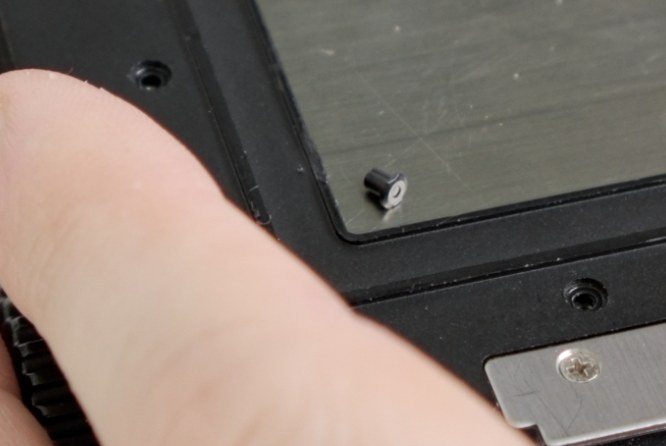 Close-up of the small loose darkslide-release peg sitting on the film back.