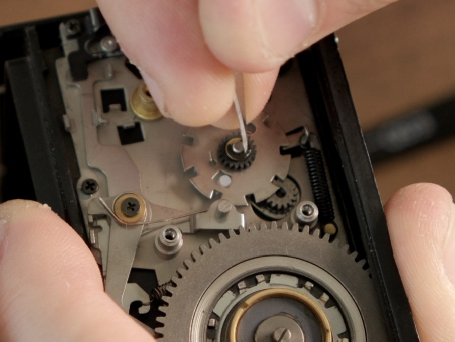 E-ring being removed from the frame spacing assembly post with a pick.