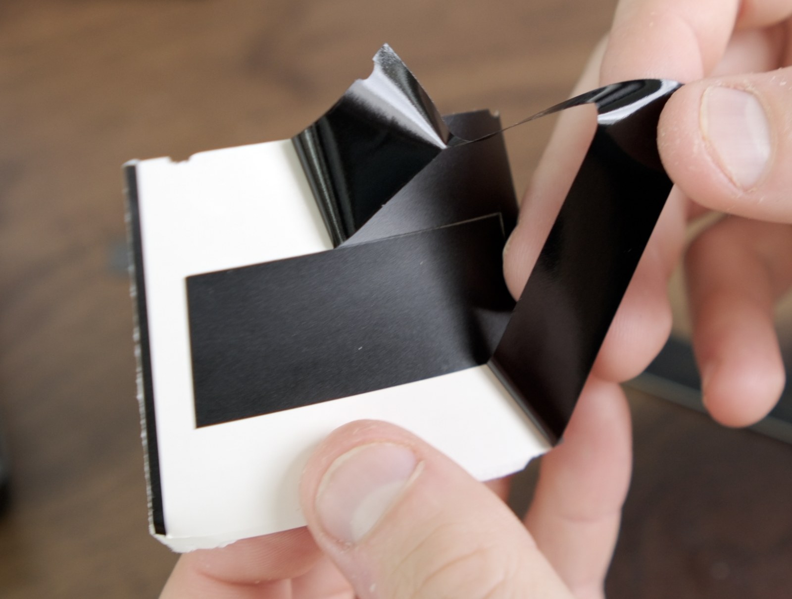 Vinyl gate mask being peeled from its backing paper.