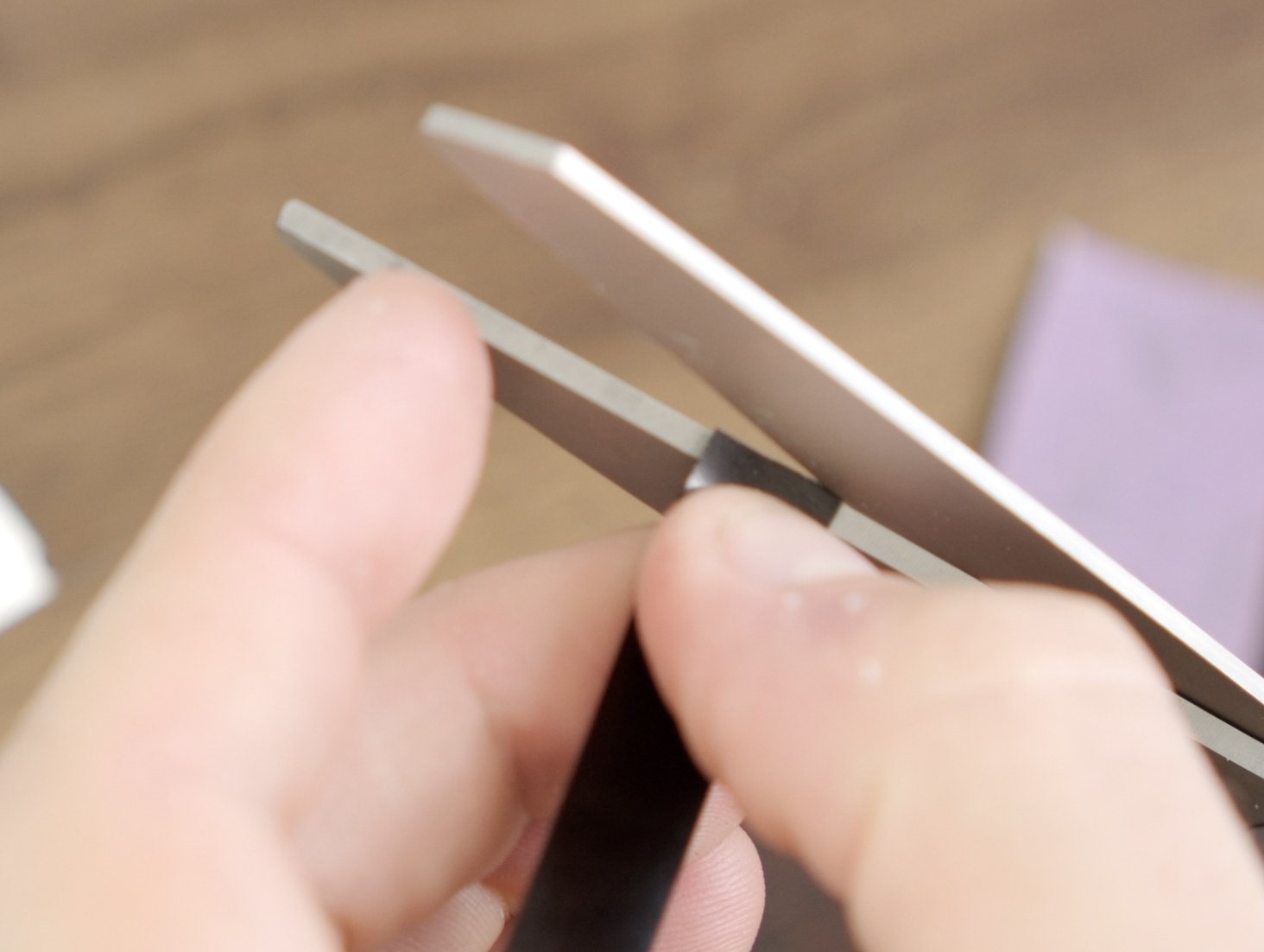 Short end of a PET masking strip being trimmed with scissors.