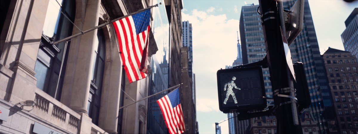 American flags and crosswalk in city light