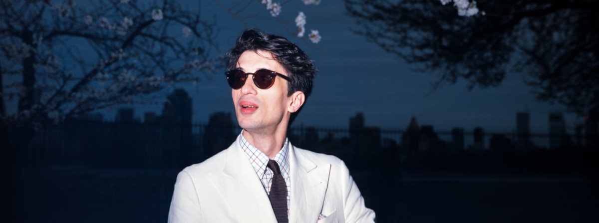 Portrait of a man in a white suit at blue hour