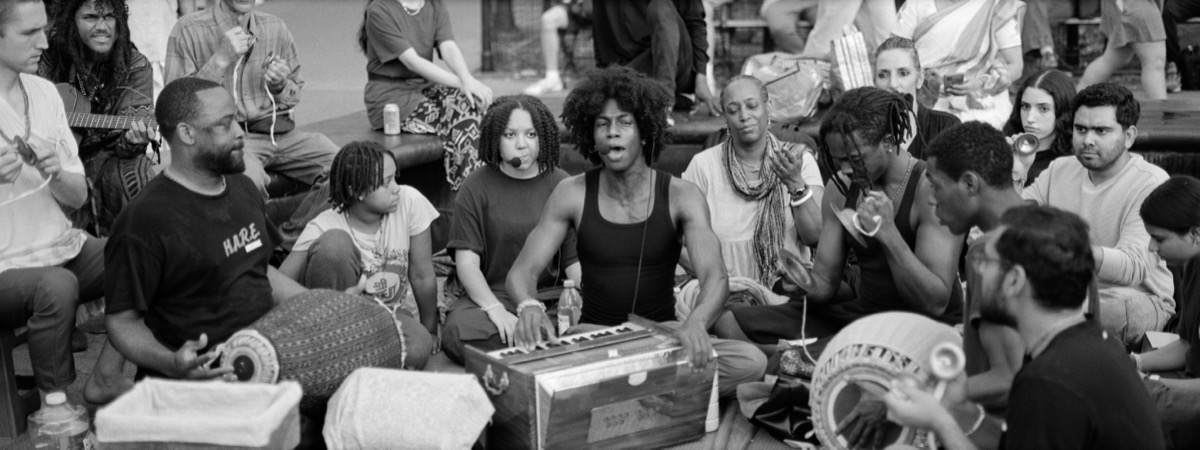 Group playing music in a circle, black and white